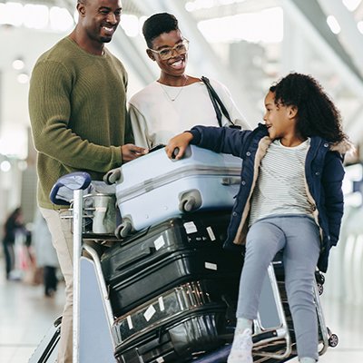 A family setting off on holiday with some suitcases.