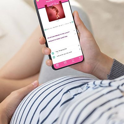 An expecting woman looking at Emma's diary on a phone.