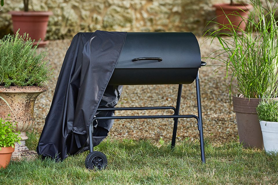 An Argos Home Drum Charcoal BBQ with a cover.