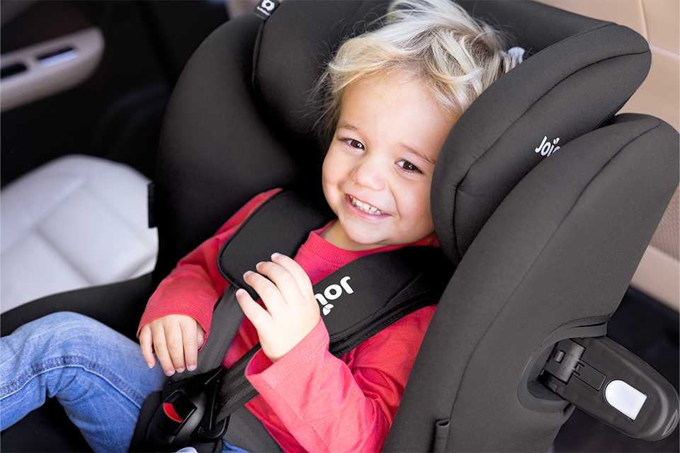A child in a Joie i-Spin 360™ car seat rear facing ready to travel in the car.