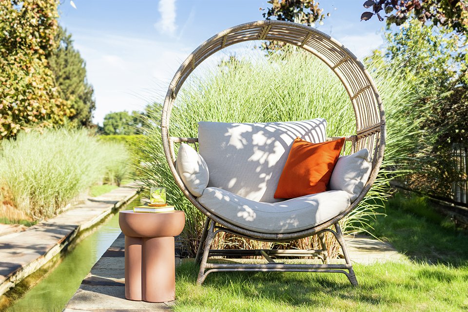 A Habitat Selene natural rattan effect garden egg chair.