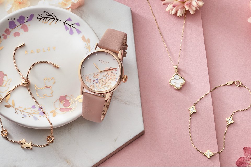 A Radley watch and a rose gold jewellery set.