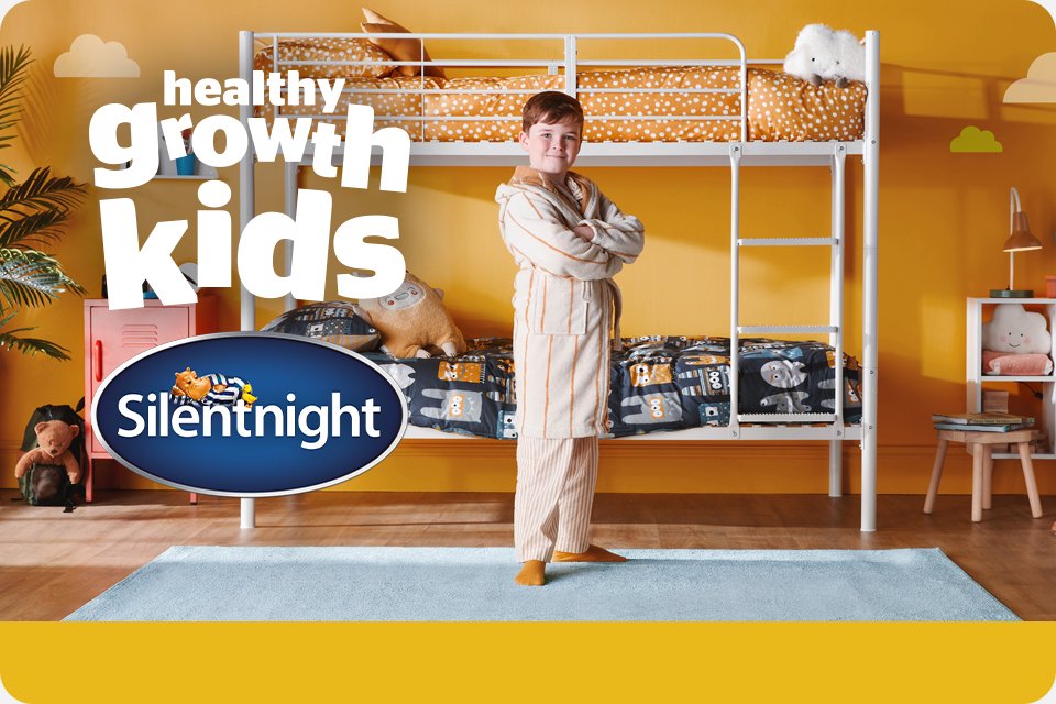 Kid standing in front of a bunk bed arranged with Silentnight Healthy Grow kids mattress.