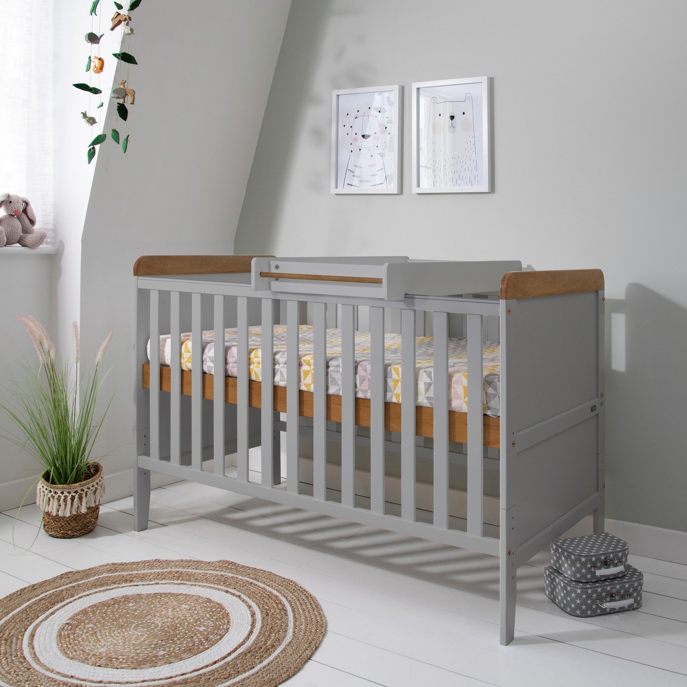 grey cot and mattress