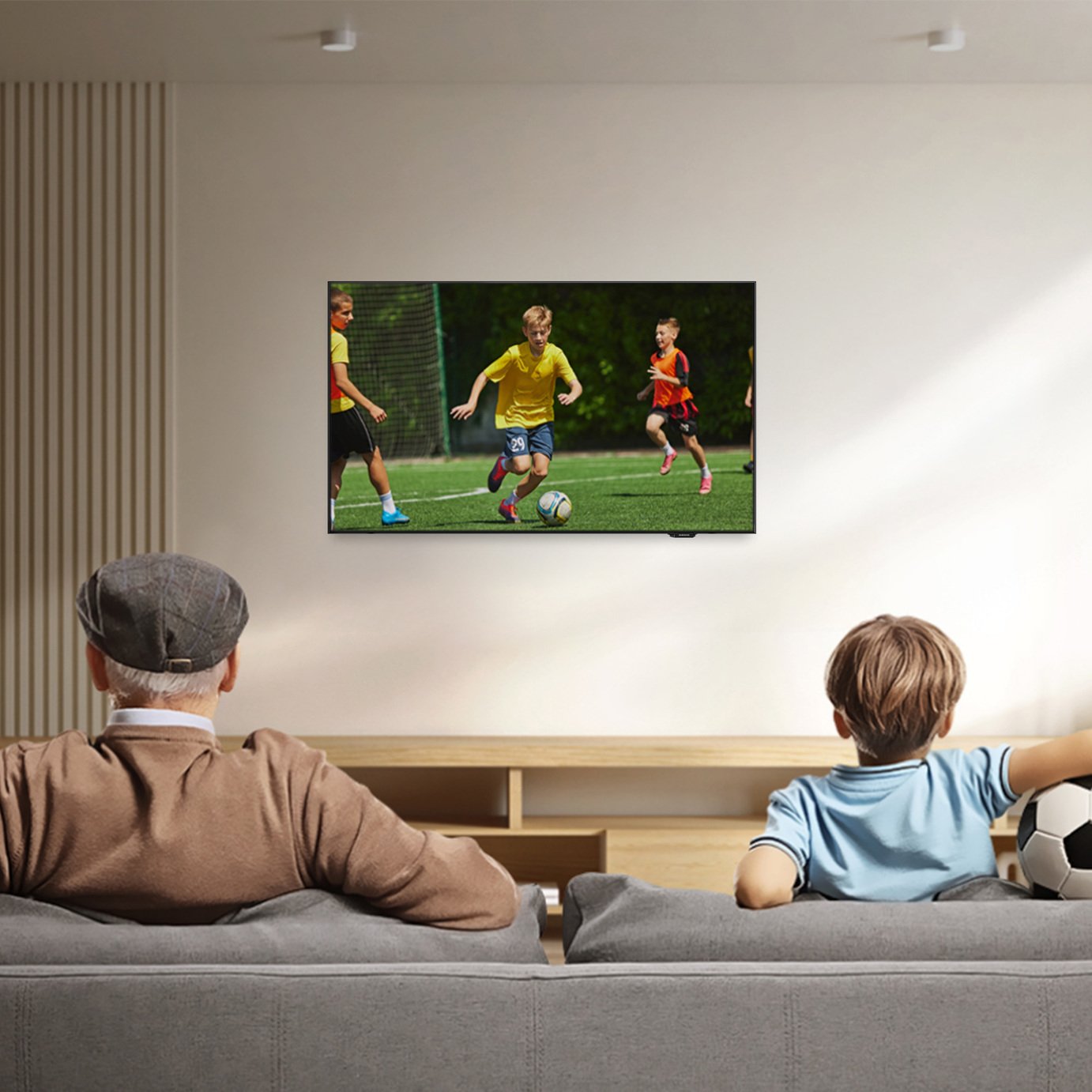 a man and boy watching a TV