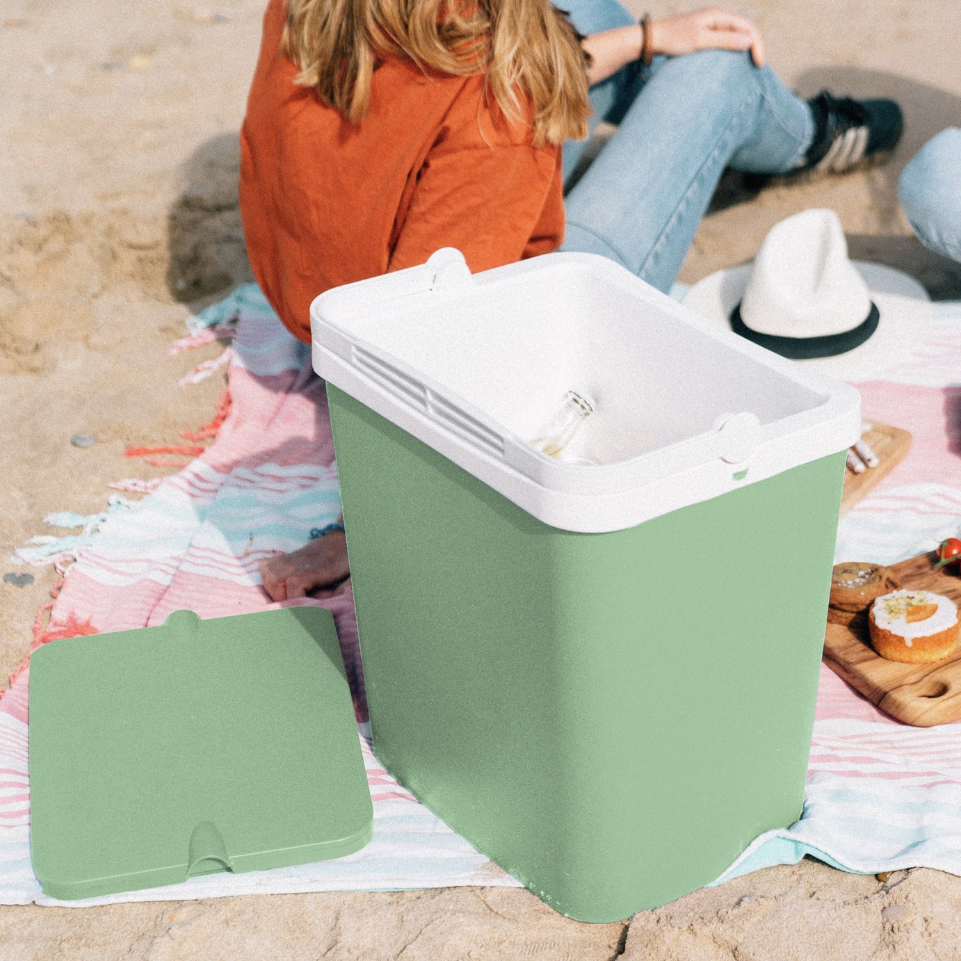 cooler box on beach with drink and snacks inside keeping cool