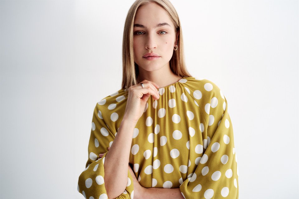 Women in yellow polkadot blouse.