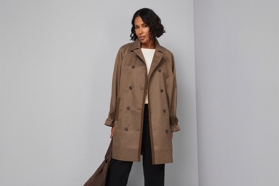 Woman in Brakeburn patterned dress and green coat.