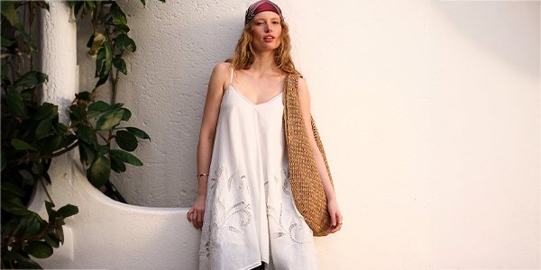 Woman wearing white lace cami dress.