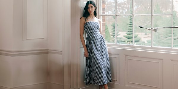 Woman wearing chequed midi dress.