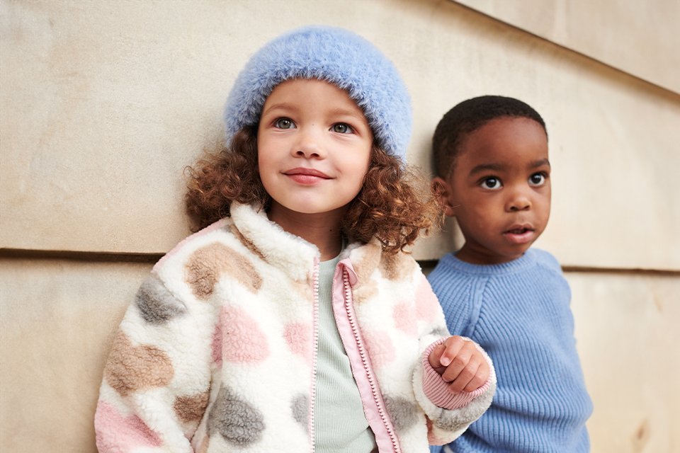 Boy and girl in autumn clothing.