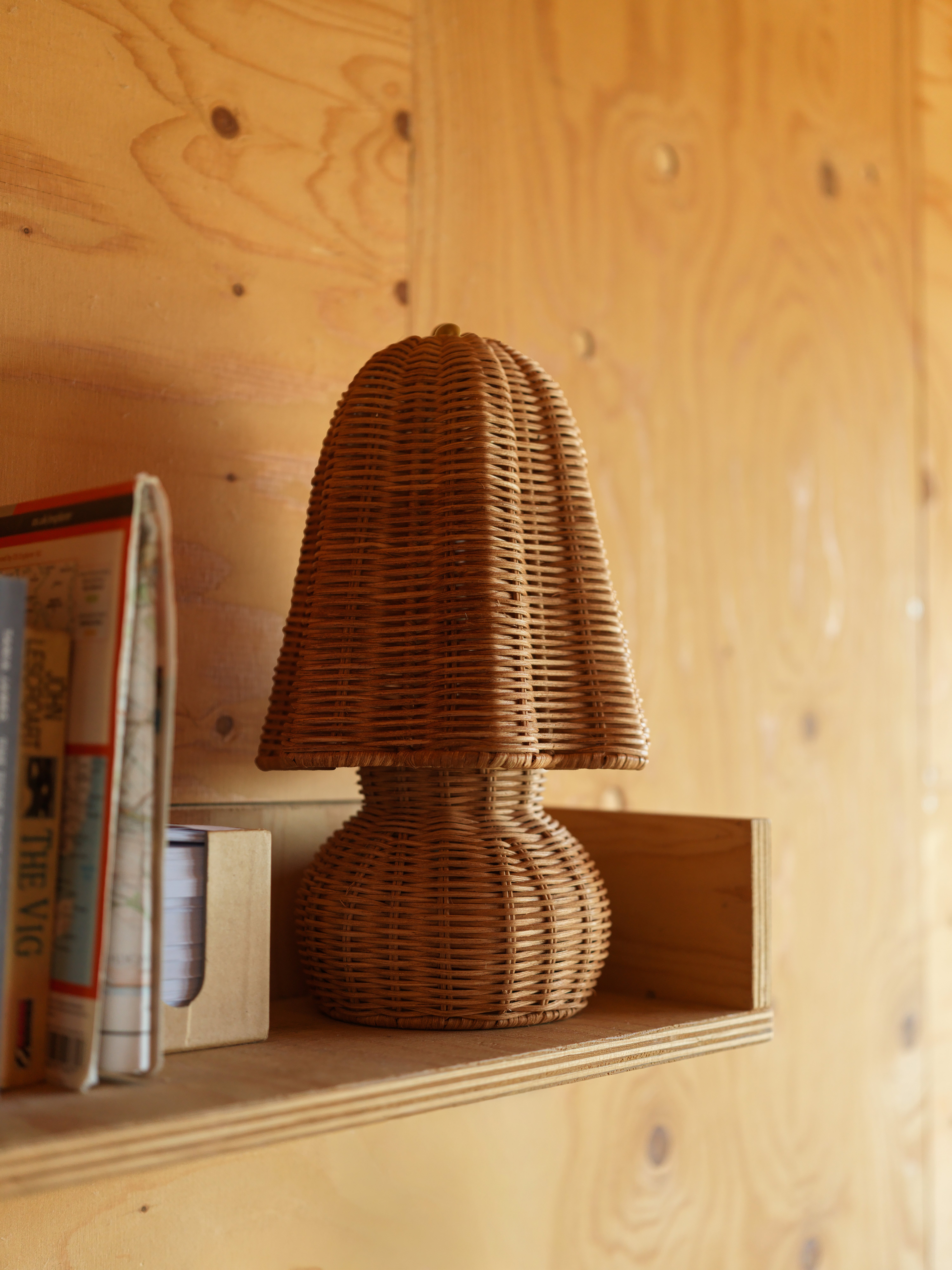 wicker lamp on wooden shelf 