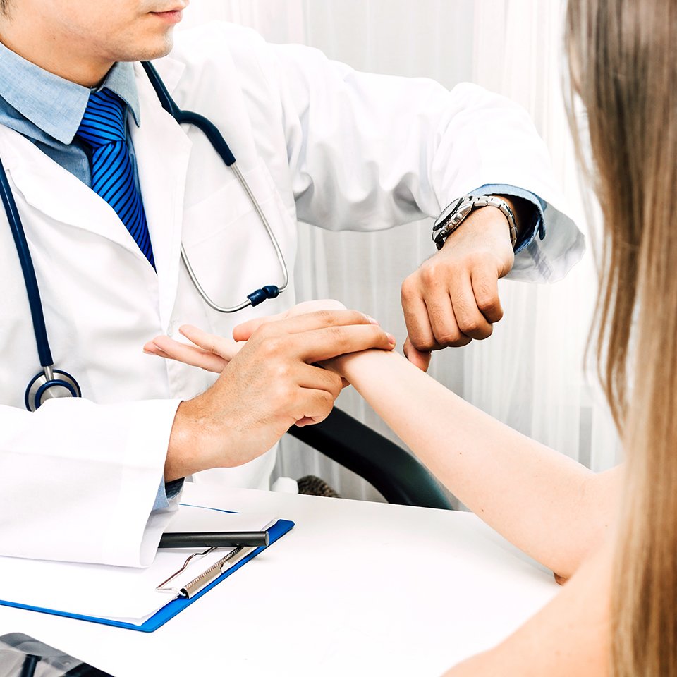 doctor checking pulse 