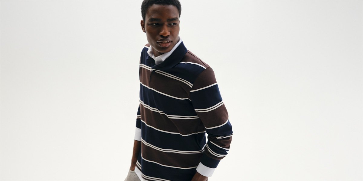 Man wearing stiped rugby style long sleeve top.