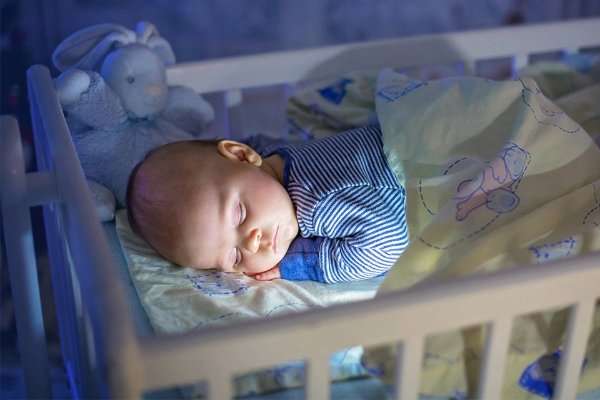 baby sleeping in a cot