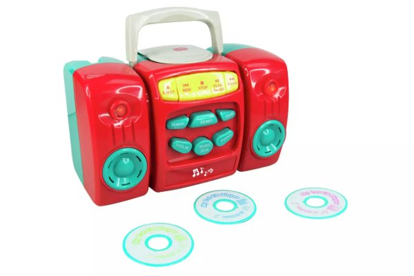 A girl playing with a toy washing machine.