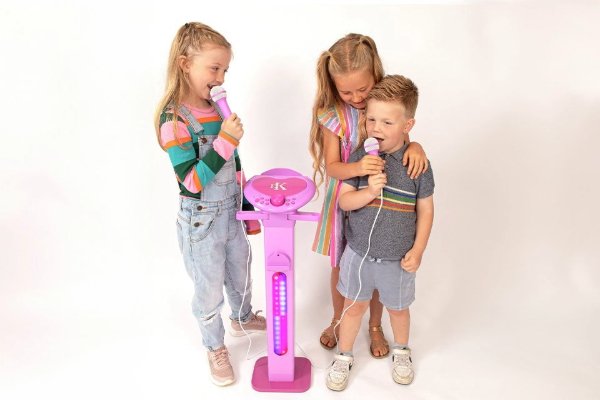 Three children singing into microphones.
