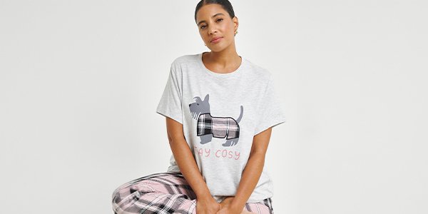 Woman in pyjama set with stay cosy slogan