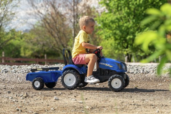 A child riding on a toy tractor.