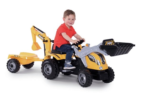 A child riding a tractor toy.