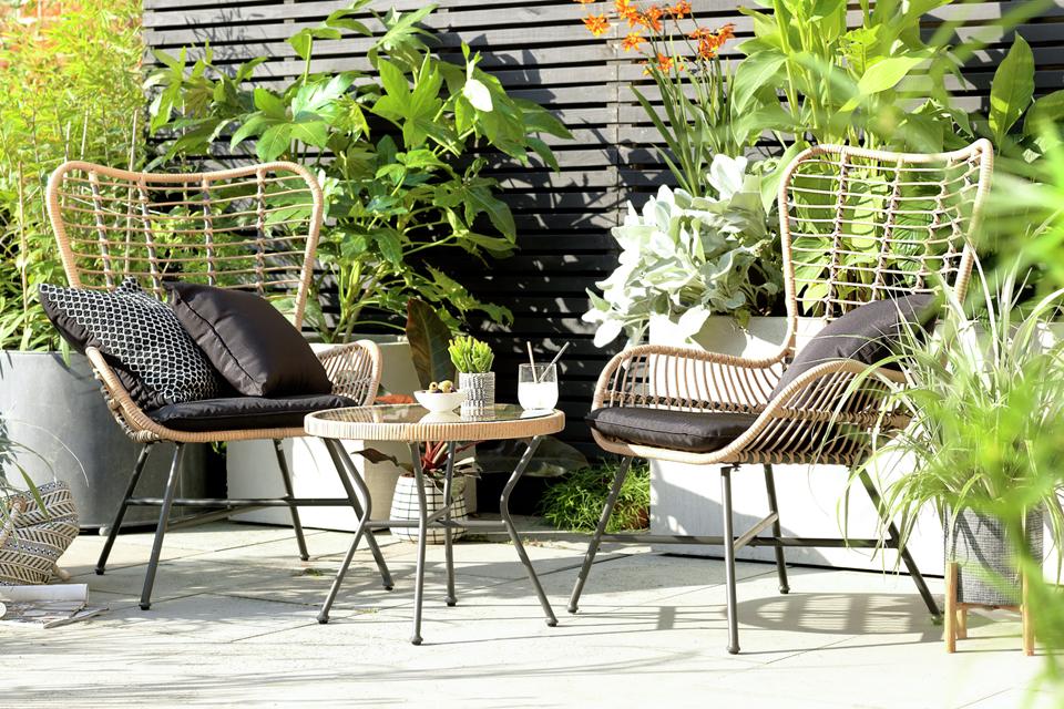 A natural finish 2 seater bamboo bistro set with black cushions. 