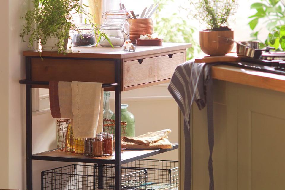 A Habitat metal and wood kitchen trolley with indoor planters and kitchen essentials on it. 
