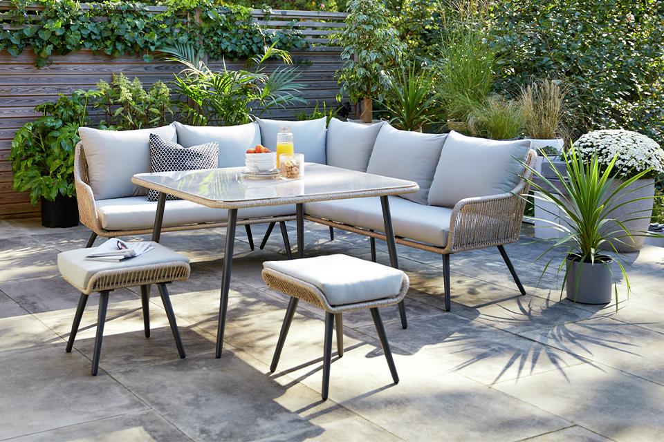 A Habitat 6 seater steel corner dining set with a smoked glass tabletop and 2 smart stools.