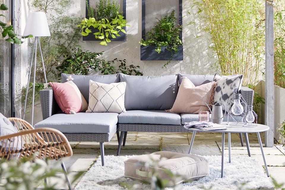 A beautiful home garden with a sofa set and coffee table.