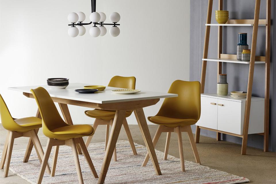 A set of Habitat Jerry yellow dining chairs and a dining table in a room.