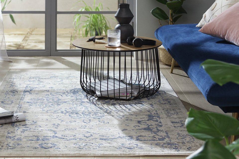 A living room setup with Habitat Traditional Natural & Blue Cut Pile Rug, a coffee table and a sofa.