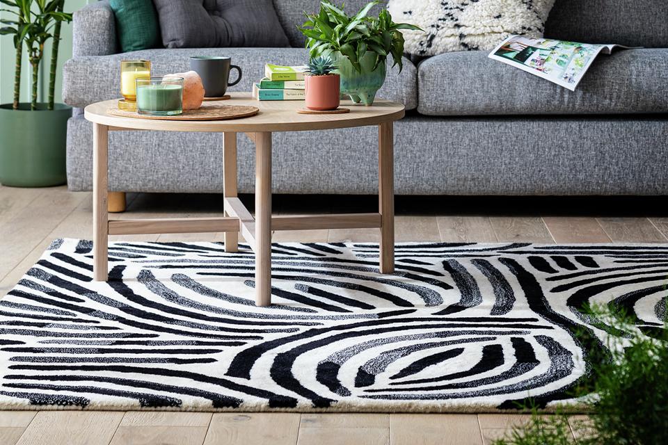 A Habitat scandi style brush marks rug in monochrome placed in a living room.