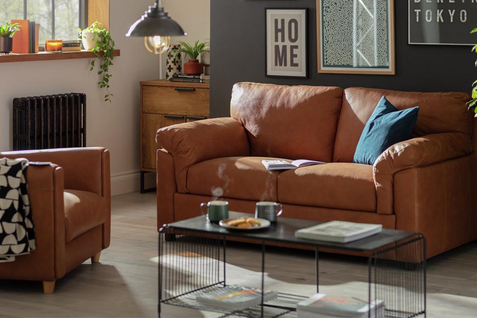 A Habitat Florence 2 seater leather tan sofa in a living room.