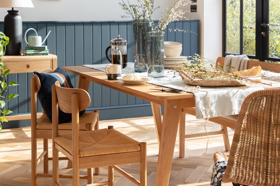 Light oak dining room set with tableware.