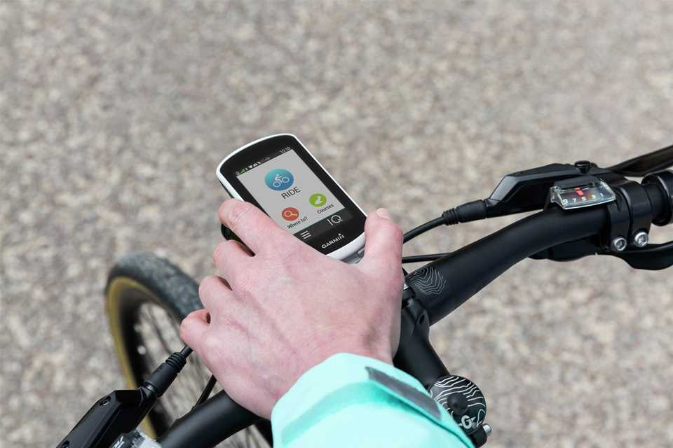 A person using a Garmin Edge explore GPS bike computer.