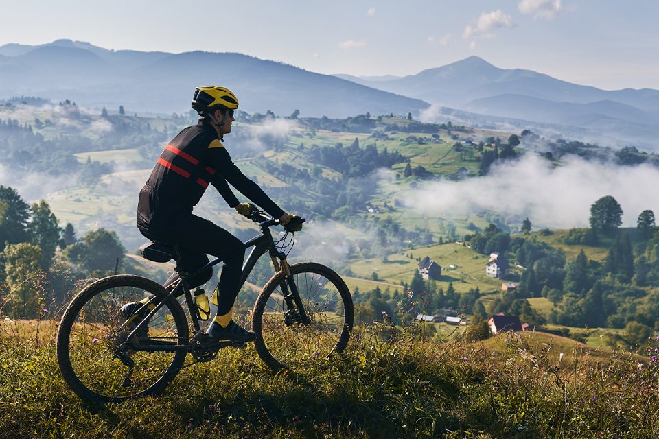 A person riding on a bike on a mountain side.
