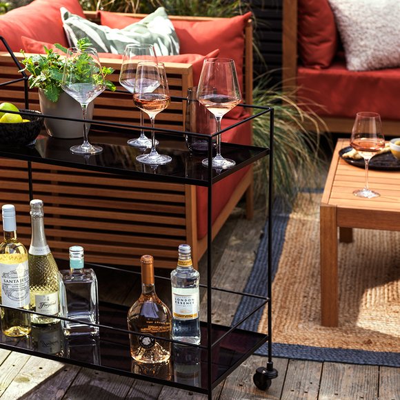 Outdoor drink trolley kept next to a sofa set.