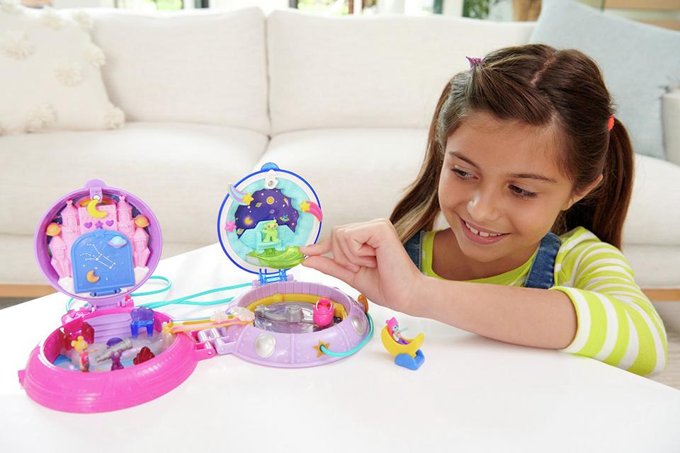 Girl playing with the Polly Pocket Double Play Space Micro Compact Playset.