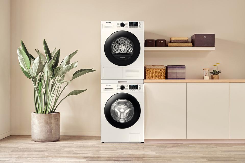Samsung washing machine and tumble dryer stacked on top of each other in a beige utility room.