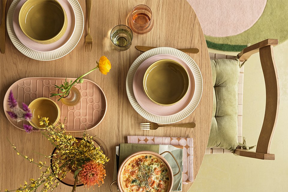 A dining table set with serveware.