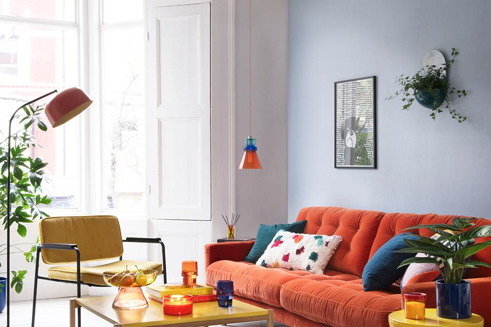 Orange floor lamp in colourful living room.