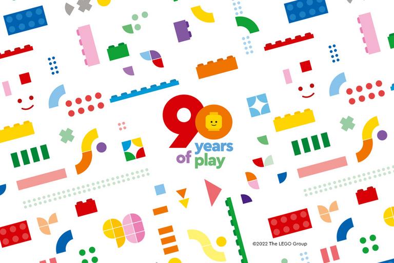 a brightly coloured block featuring multicoloured illustrations of LEGO® blocks and the 90 years of play logo.