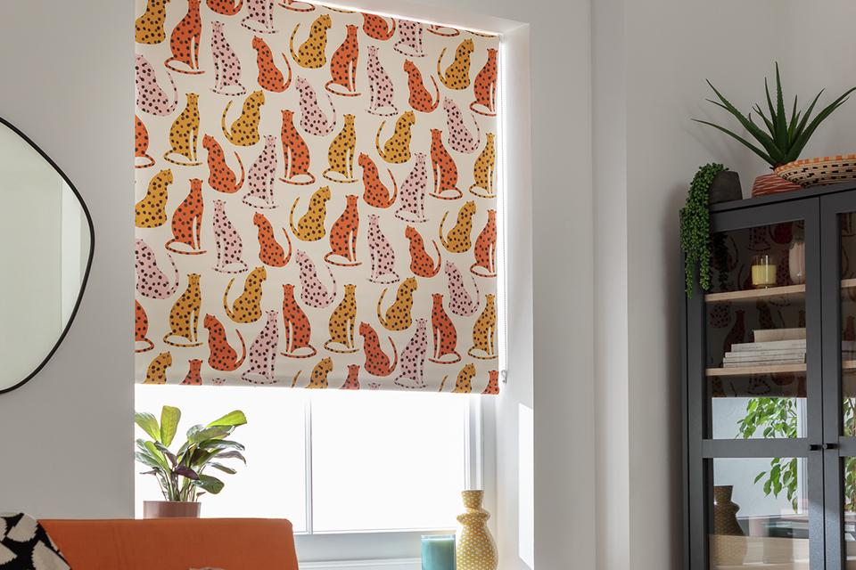 A cheetah print Habitat blackout roller blind in orange and yellow.