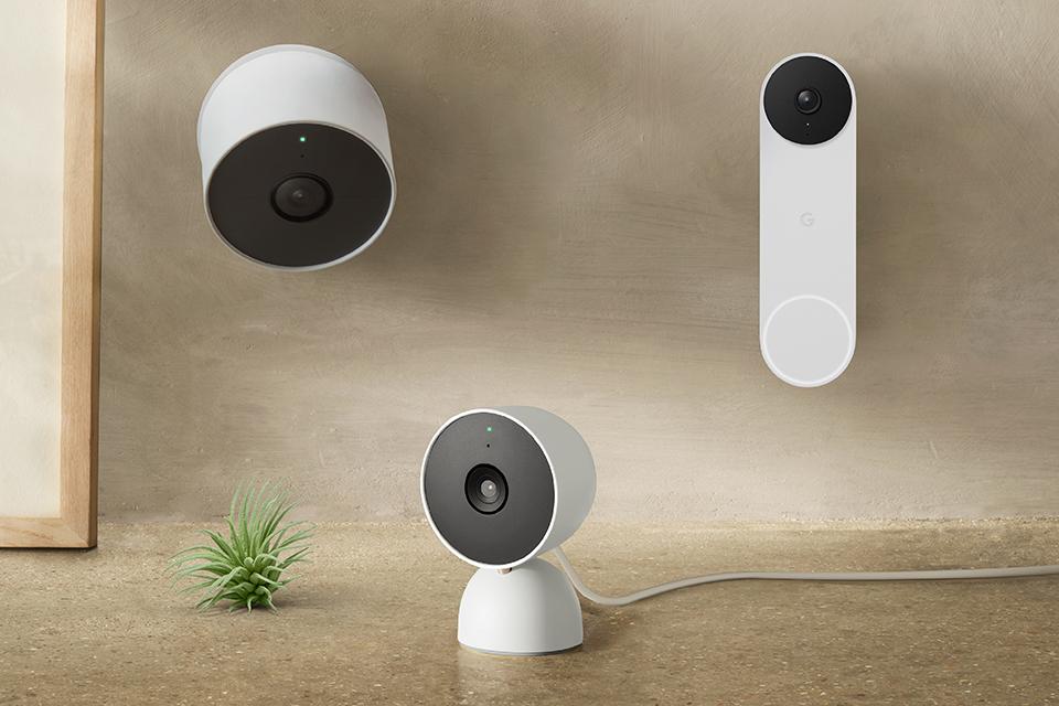 2 Google Nest security cameras and a video doorbell next to an indoor plant.