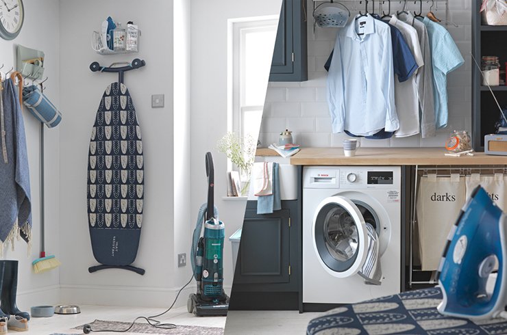 An ironing table, a washing machine, an iron, and clothes hanging on a rail in a utility room.