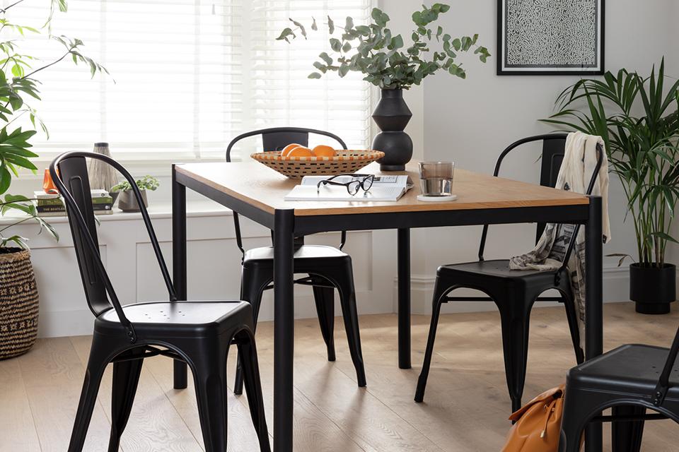 A modern dining room with black chairs and tables.