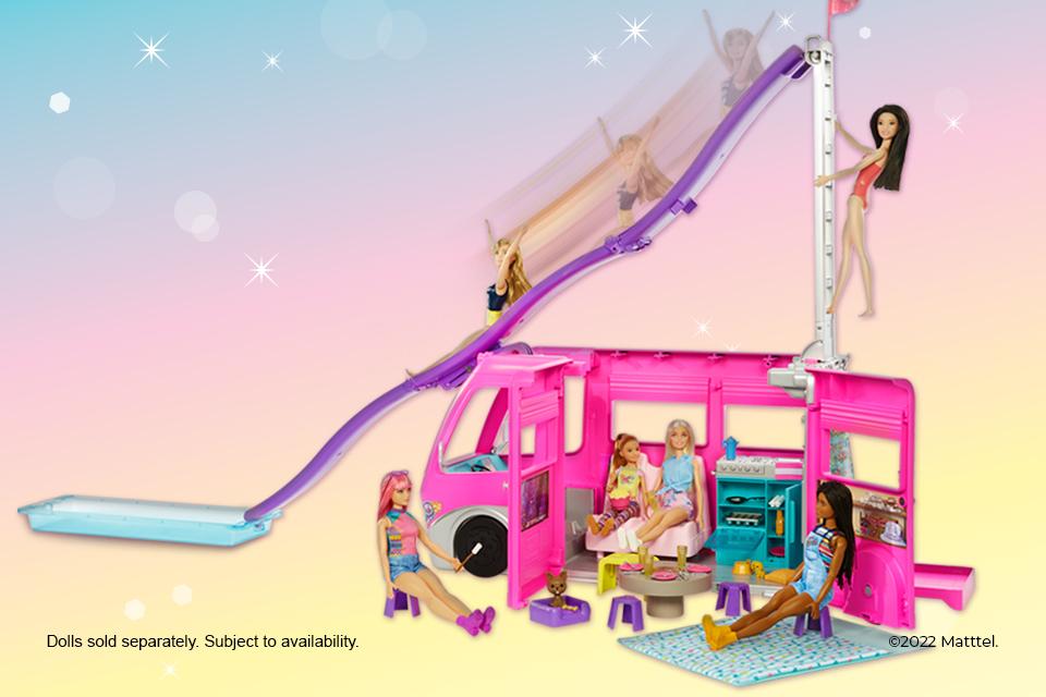 Barbie dolls chilling next to their Dreamcamper vehicle playset with slide and pool.