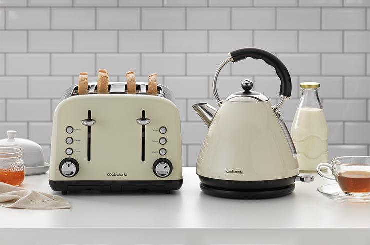 A picture of a matching cream kettle and toaster in a white kitchen.