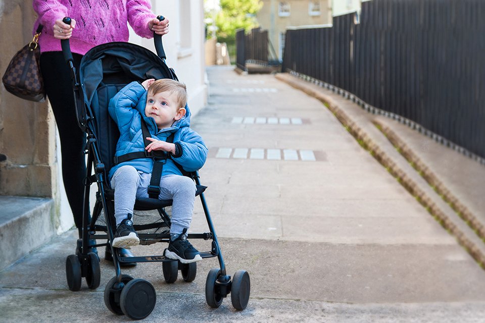 A mother with her toddler in Red Kite The Push Me 2U Stroller - Midnight Black.