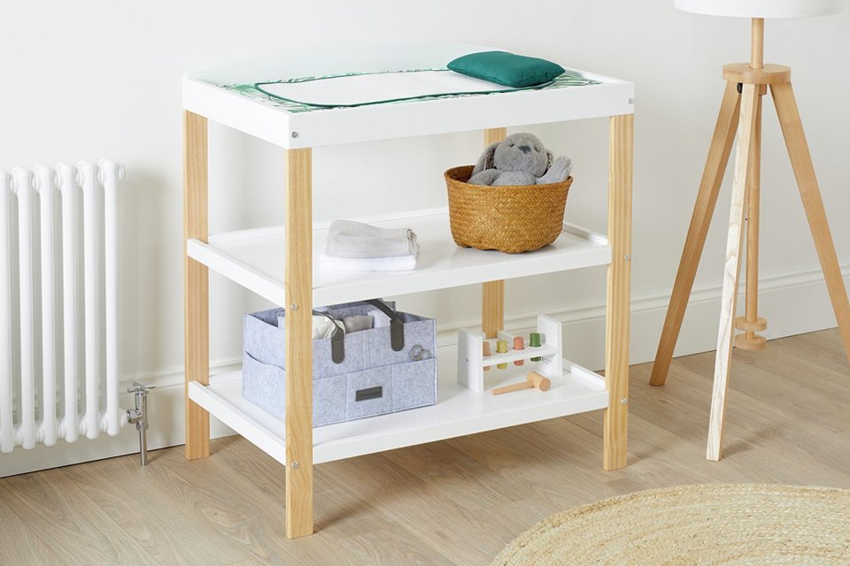 A baby mat, a storage basket and a box on an Ickle Bubba Coleby Scandi open changing unit.
