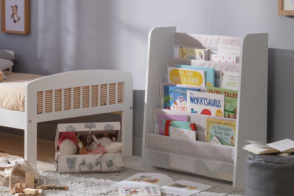 Children's books in a Habitat white kids book tidy.